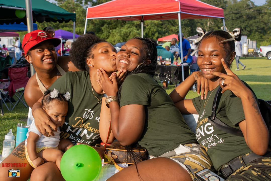 Family members in matching green shirts laughing together at Cousins Day