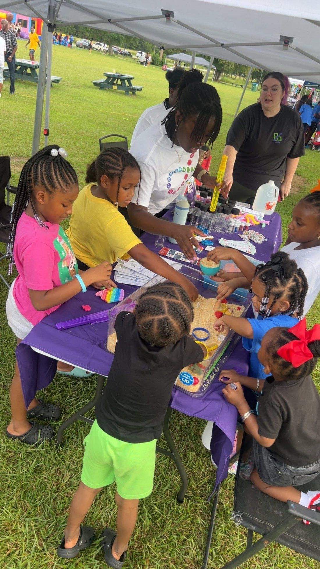 Children exploring a hands-on sensory table in the Kids Zone