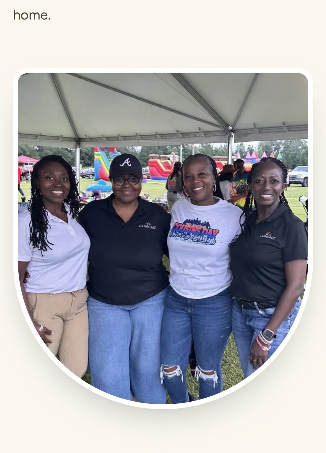 Volunteers and Comcast partners gathered under the tent at Cousins Day