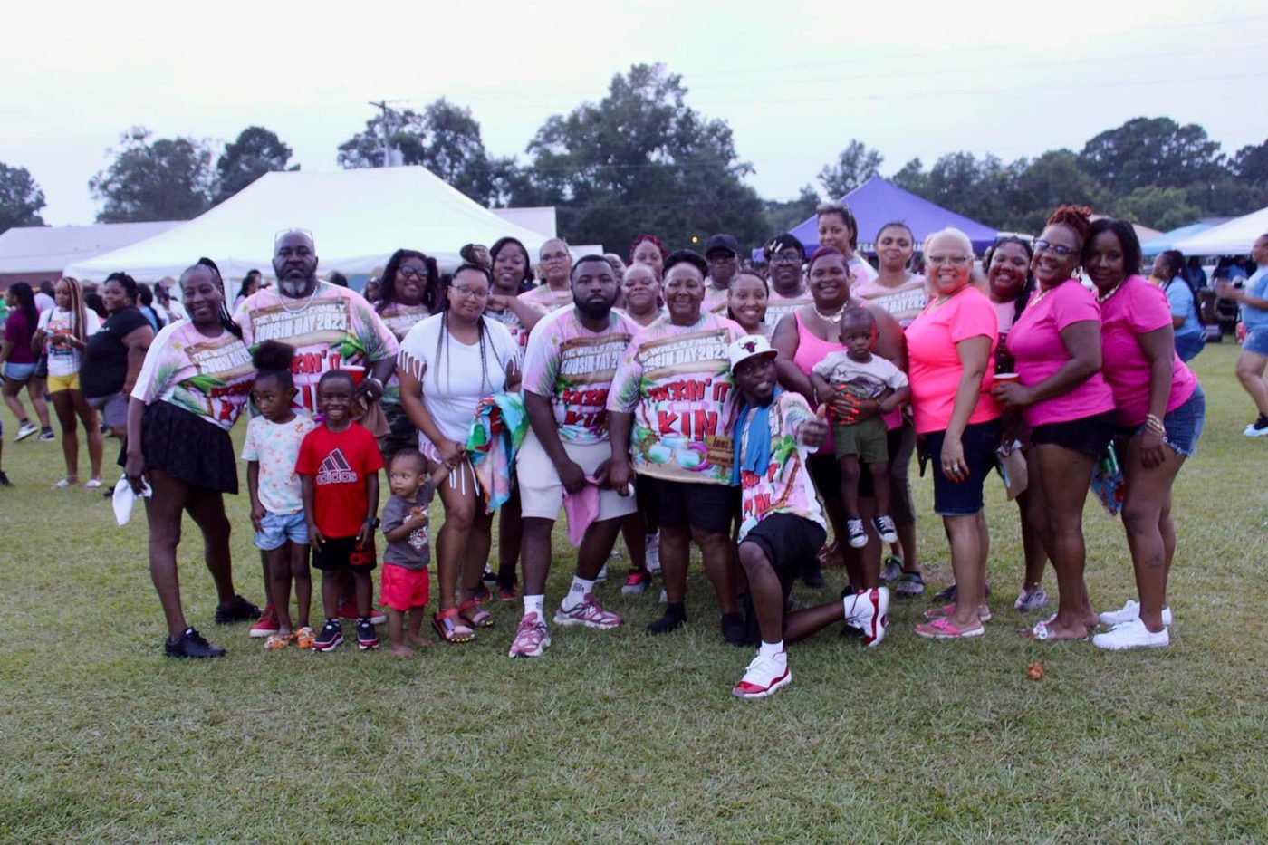 The Walls family in pink Cousins Day shirts with the kids up front