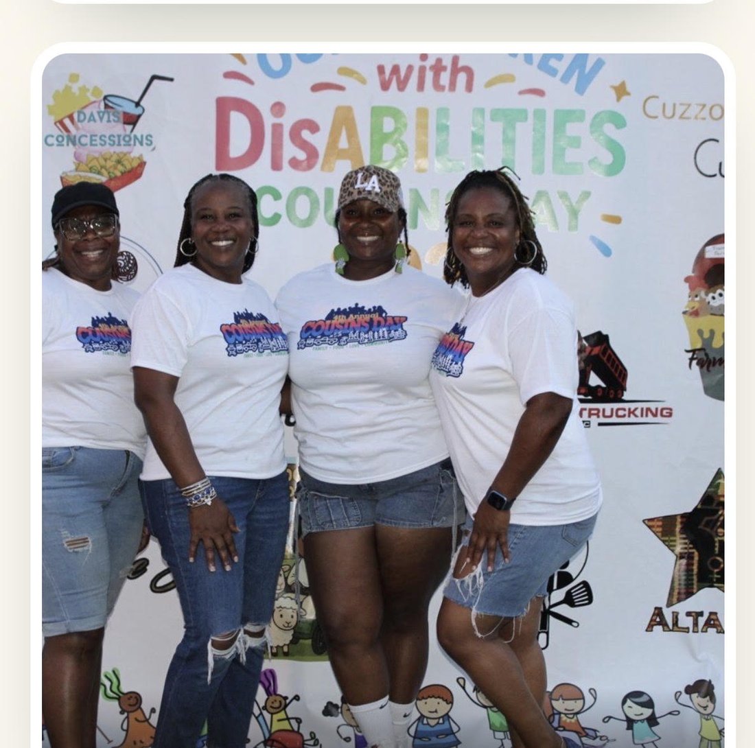 Four women in matching Cousins Day shirts in front of the welcome backdrop